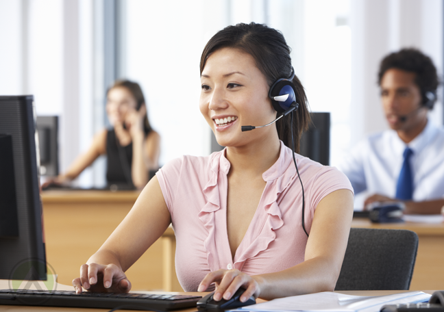 gallery/female-asian-call-center-agent-attending-to-a-customer-with-coworkers-at-the-back